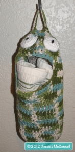 green crochet clutter plastic bag eating monster